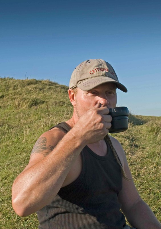 Andy imbibes foot-fuel at Mount Caburn.